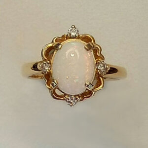 9 x 7 Oval shaped Opal set in a fancy ring with 0.06 diamonds.
