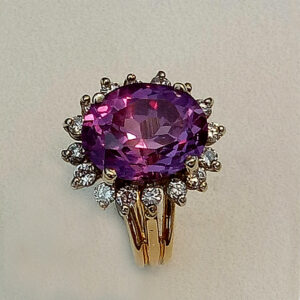 Oval shaped Created Alexandrite 12 x 10 with a 0.50ct diamonds ring.